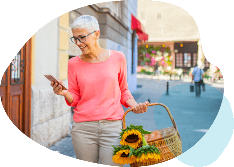 Woman walking the street looking at wellframe app